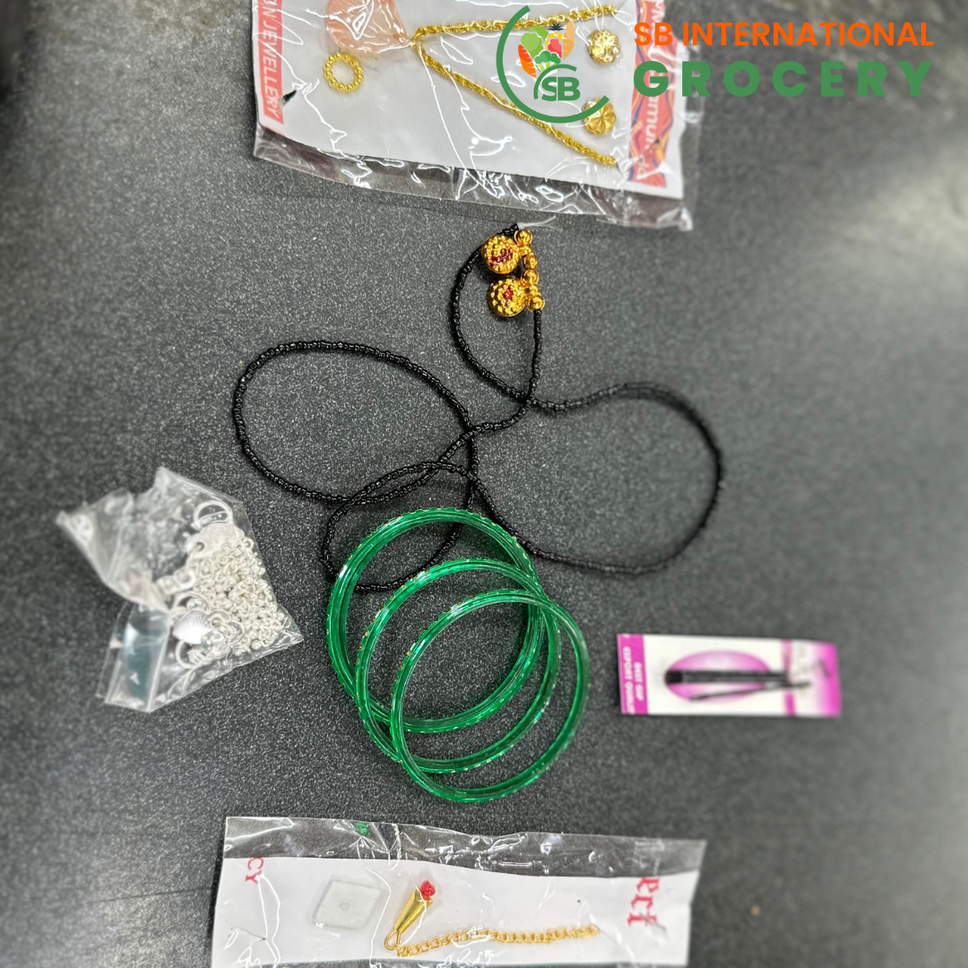 Jewelry items including green bangles, necklaces, and earrings on a dark surface with 'SB International Grocery' branding.